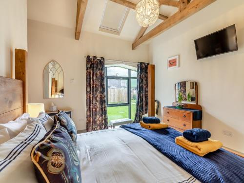 a bedroom with a large bed and a tv at The Hemmel - Uk43357 in Branxton