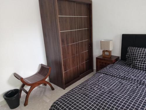a bedroom with a bed and a chair and a door at La Grace in Ungasan