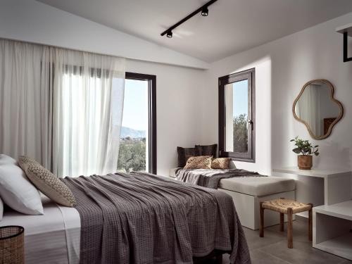 a bedroom with two beds and a large window at Estelle Luxury House in Zakynthos