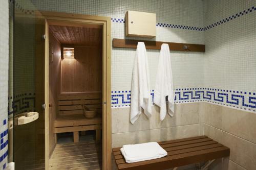 a bathroom with a shower and a toilet with towels at Commune in Hong Kong