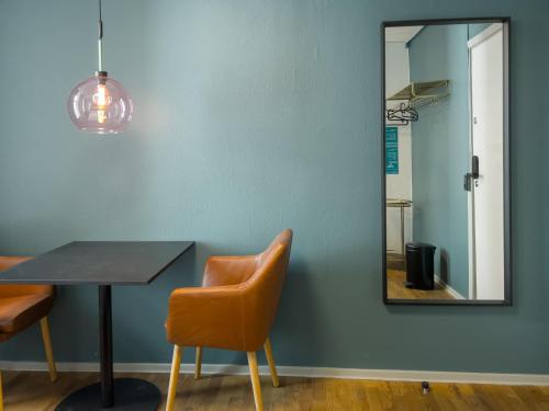 a dining room with a table and a mirror at where to sleep in Copenhagen
