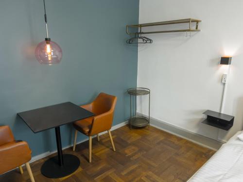 a room with a table and chairs and a bed at where to sleep in Copenhagen