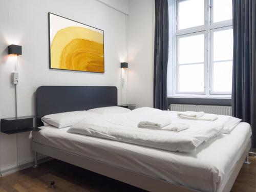 a bedroom with a white bed with two towels on it at where to sleep in Copenhagen