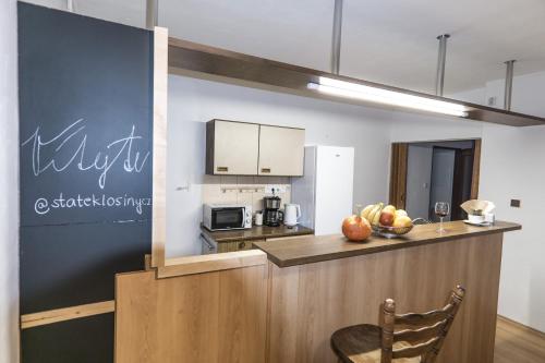 a kitchen with a counter with a bowl of fruit at Statek Losiny in Velké Losiny