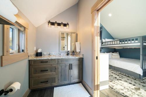 a bathroom with a double sink and a bunk bed at Rum Away with Me #303 in Chelan