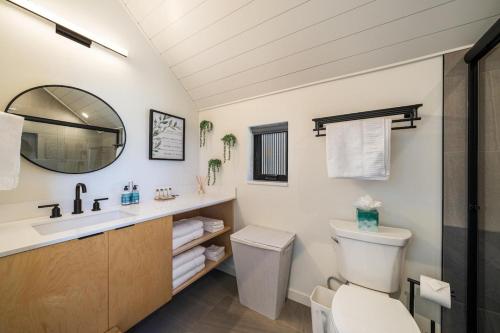 a bathroom with a sink and a toilet and a mirror at Tequila Long Time #311 in Chelan