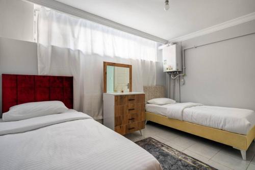 a bedroom with two beds and a mirror at Central Istanbul Apartments in Istanbul