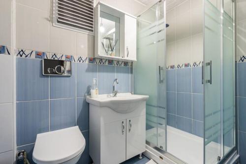 a bathroom with a toilet and a sink and a shower at Central Istanbul Apartments in Istanbul