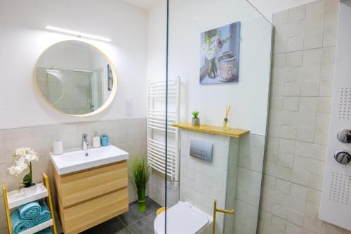 a bathroom with a shower and a sink and a mirror at Club Panorama Lakeside Apartman in Alsóörs