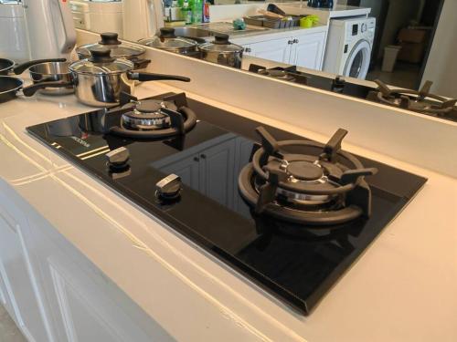 a stove top with pots and pans on a kitchen counter at Senopati Penthouse Luxury 2 Bedroom Full Furnished SCBD Area in Jakarta