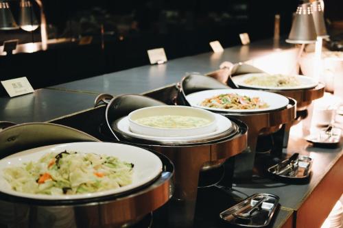 a row of plates of food on a table at Yoai Hotel in Yilan City