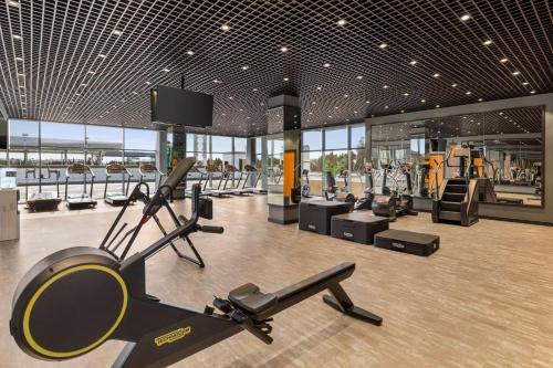 a gym with cardio equipment in a building at Wyndham Garden Baku in Baku