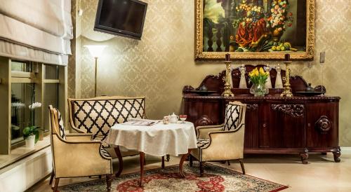 a dining room with a table and two chairs at Hotel im. Jana Pawła II in Wrocław
