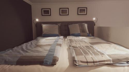 a bed with two pillows on it in a bedroom at Home, far away from Home 2 in Budapest