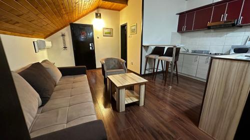 a living room with a couch and a table at Club Satelit Zlatibor in Zlatibor