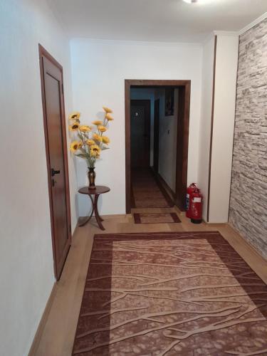 a hallway with a vase of flowers on a table at Mario Complex in Melnik