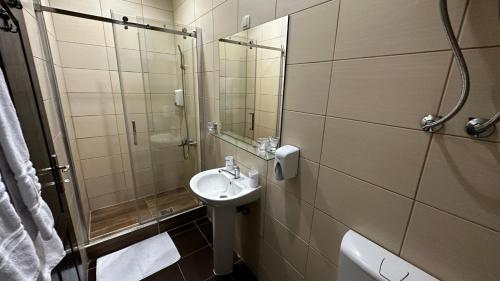 a bathroom with a sink and a shower at Club Satelit Zlatibor in Zlatibor