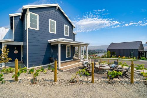 a blue house with a porch and a patio at Here Comes the Sun #123 in Chelan