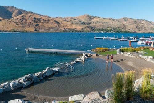 a man standing on the shore of a body of water at Here Comes the Sun #123 in Chelan