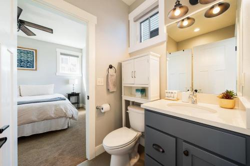 a bathroom with a toilet and a sink and a bed at On Lake Time #86 in Chelan