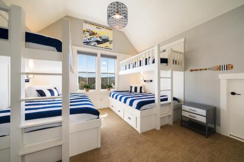 a bedroom with two bunk beds with blue and white stripes at On Lake Time #86 in Chelan