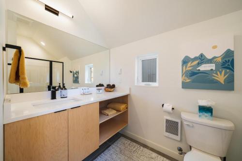 a bathroom with a sink and a toilet and a mirror at Glamping at the Lake #310 in Chelan