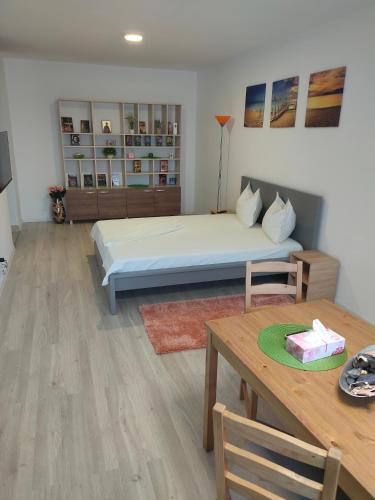 a bedroom with a bed and a table with a cake at DC Ghencea 158 Self Check-in in Bucharest