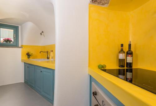 a kitchen with two bottles of wine on a counter at Calliope's Villa with jacuzzi in Pyrgos