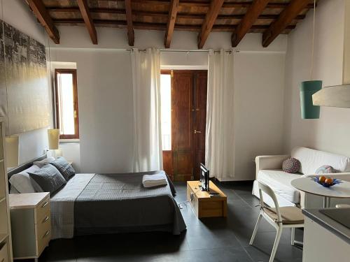 a bedroom with a bed and a couch and a table at Valencia Central Loft in Valencia