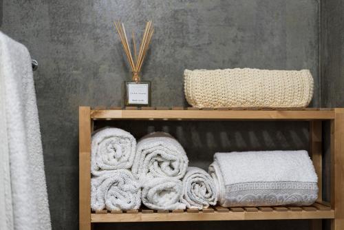 a wooden shelf with towels on it in a bathroom at Fred's House Asprela in Porto