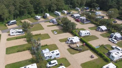 an aerial view of a parking lot with parked vehicles at Glamping at Back Of Beyond Touring Park in Saint Leonards