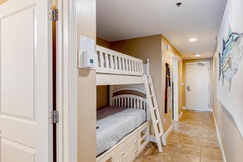 a bunk room with a bunk bed and a staircase at Sterling Breeze 1705 in Panama City Beach