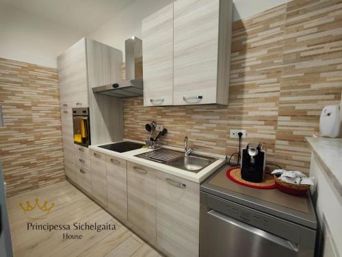 a kitchen with a sink and a counter top at Principessa Sichelgaita House in Salerno