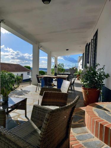 a patio with wicker chairs and a table on a patio at Herdade da Fonte Ferreira in Avis