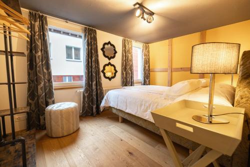 Postel nebo postele na pokoji v ubytování Home Hotel Arosa