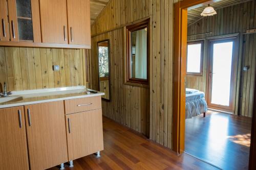 a kitchen with wooden walls and wooden floors at Tree Houses Hotel in Fethiye