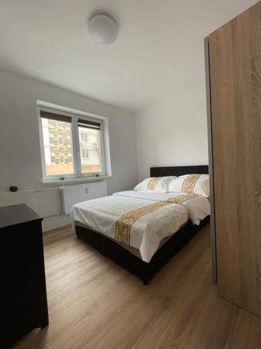 a bedroom with a bed and a window at Apartmán Miriam in Nitra