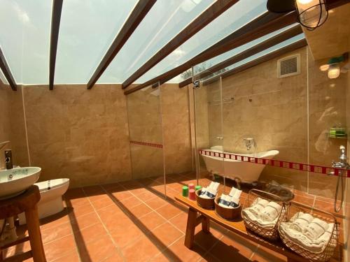 a bathroom with a sink and a tub and a toilet at Murraya Paniculata Villa in Magong