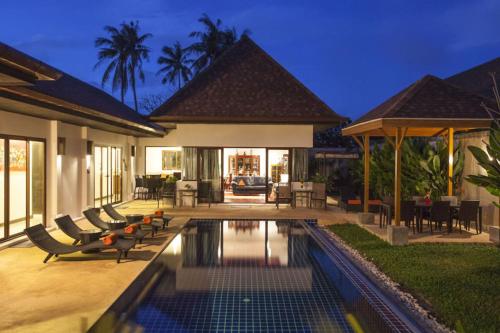 a villa with a swimming pool in a backyard at Exotic Boutique 4BR Pool Villa Toya, Gated Residence, Rawai in Rawai Beach