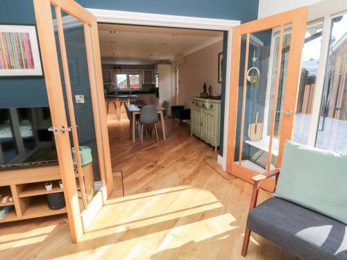 a living room with a mirror and a dining room at The Croft in Alnwick