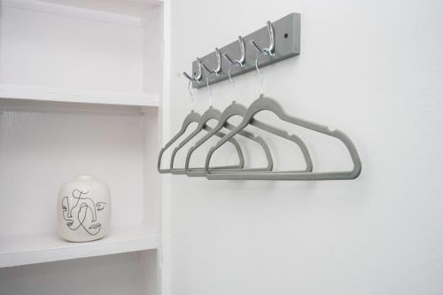 a shelf with three hangers in a white kitchen at Cowdray Avenue in Colchester