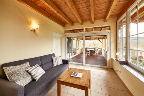 a living room with a couch and a table at Ferienhaus Graacher Himmelreich in Graach