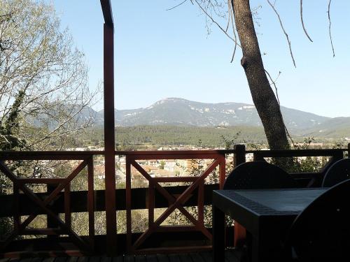 a porch with a table and a view of the mountains at CAMPING DE BESALU in Besalú