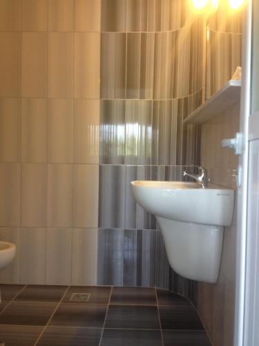 a bathroom with a sink and a toilet at Riviera Rooms in Himare