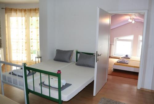 a small bedroom with a bunk bed and a mirror at Holiday Home Uma in Visoko