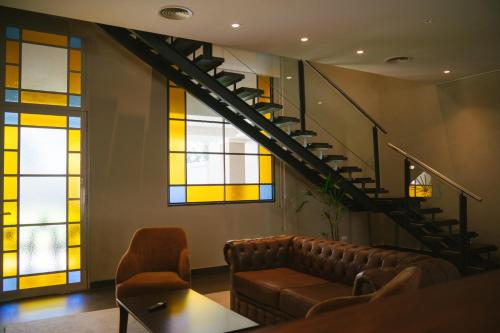 a room with a couch and a staircase with stained glass windows at Casa Agostino - Luxury wine resort in Mendoza