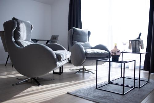 a living room with two chairs and a table at Solaris in Mostar