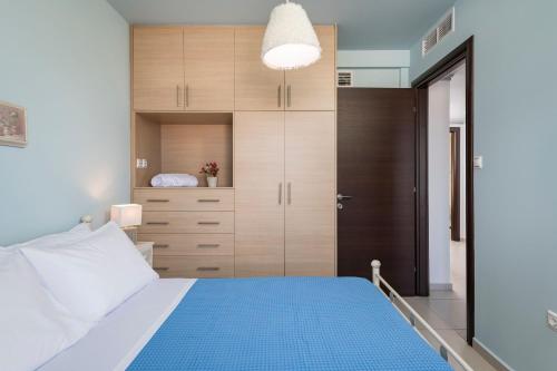 a bedroom with a large bed with a blue floor at Villa Antoni in Galatás