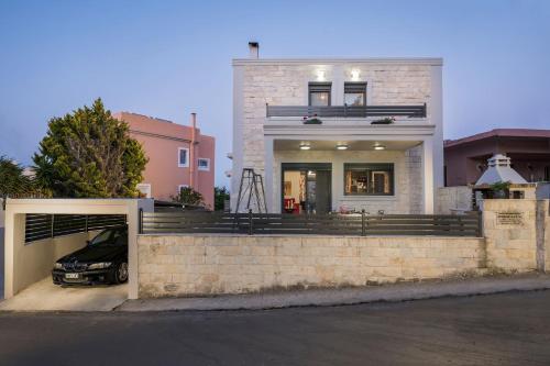a house with a car parked in front of it at Villa Antoni in Galatás