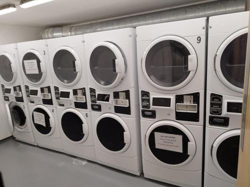 a row of white washing machines in a laundrette at Earl Street 122 in Sheffield